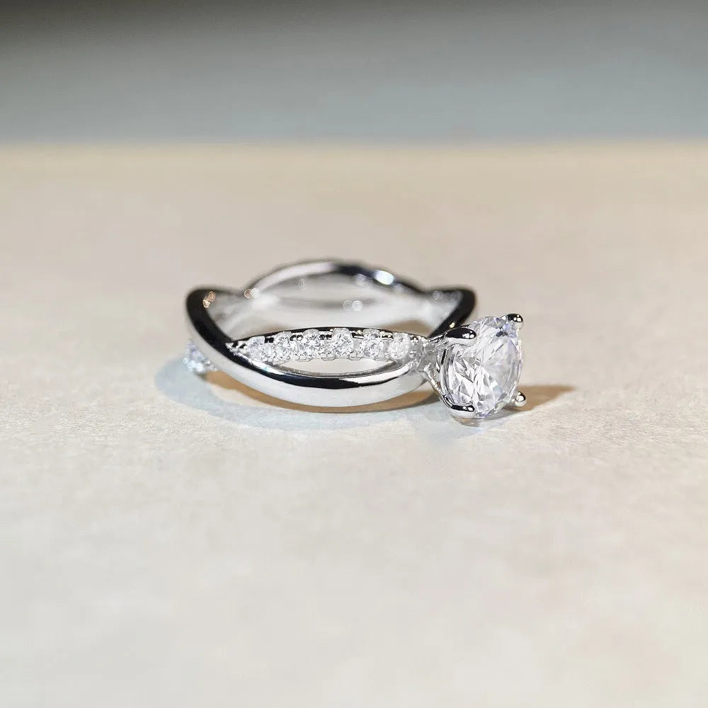 Silver geometric twist band ring with a 1-carat Moissanite stone in a four-claw setting.