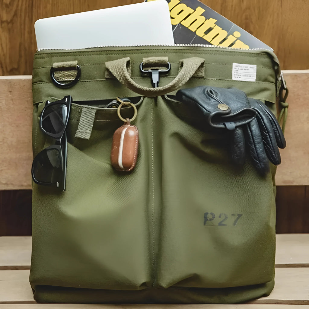 Medium canvas crossbody messenger bag in military green showing laptop compartment and shoulder strap