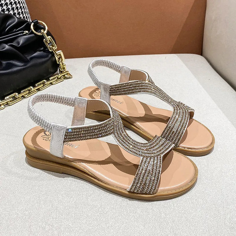Women's patent leather beach sandals with rhinestones on a round toe, shown in gold colour.