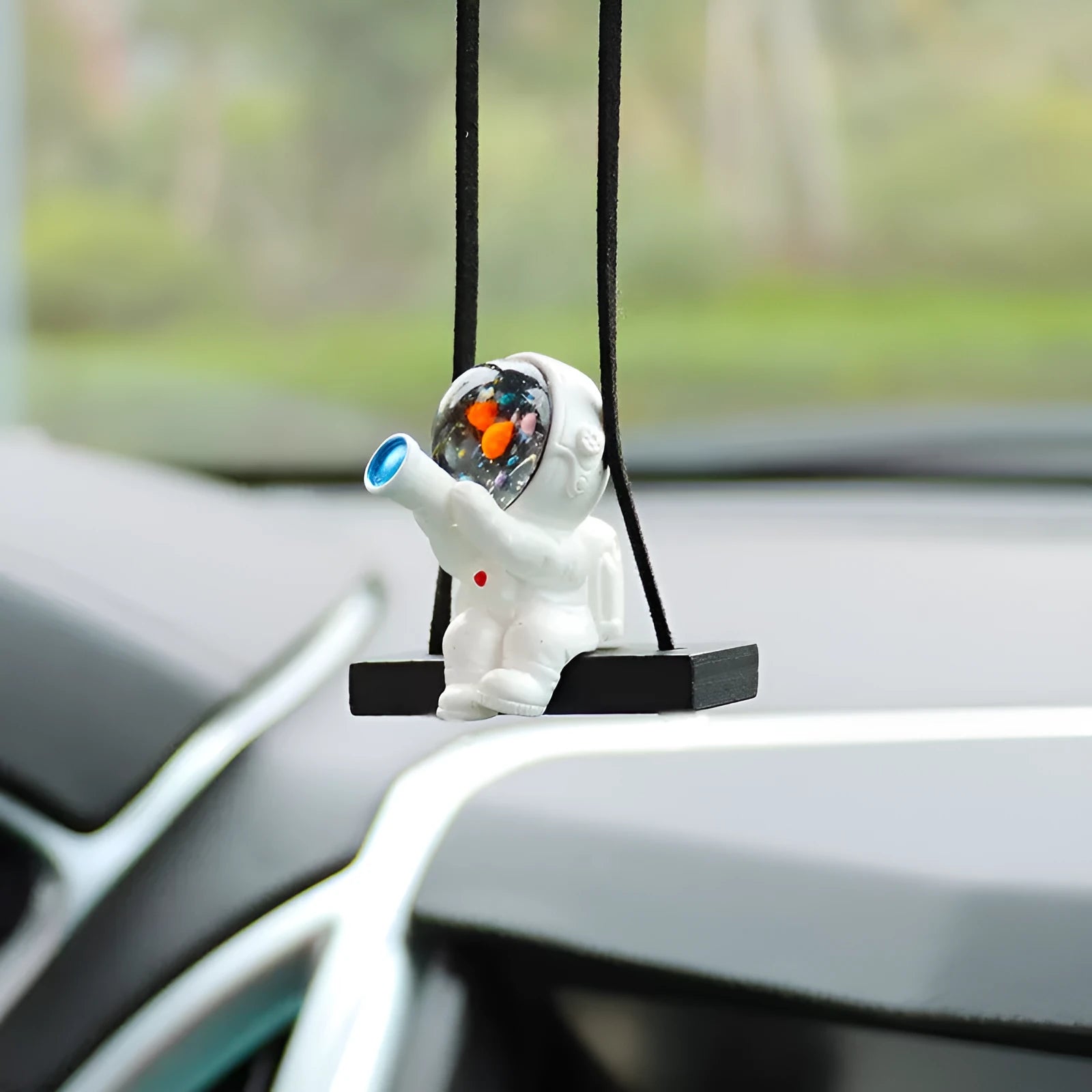 Resin cartoon astronaut car pendant decoration hanging from a rear-view mirror.