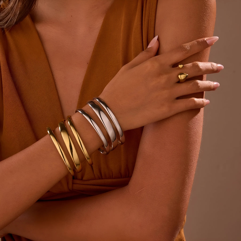Gold and steel colour geometric line design stainless steel bracelet for women with simple opening clasp.