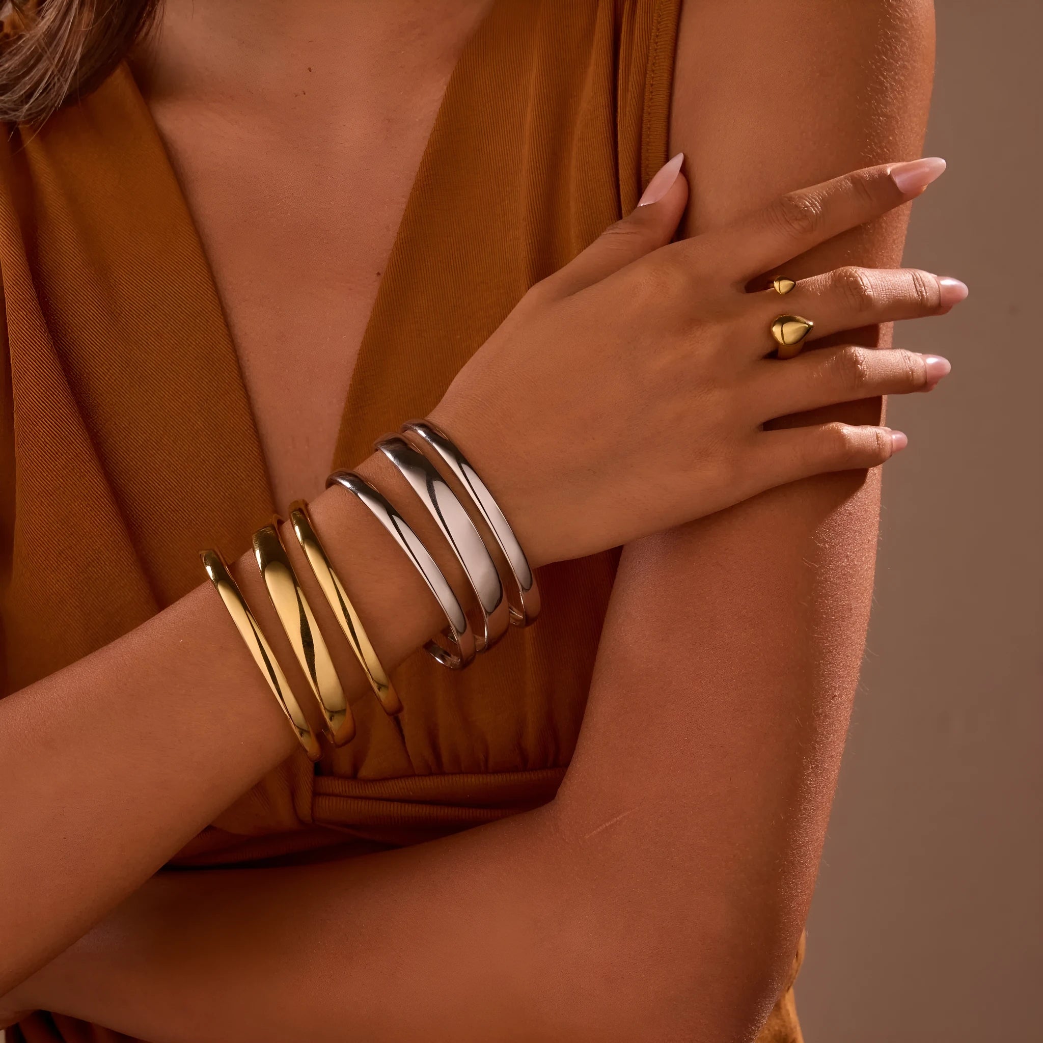 Gold and steel colour geometric line design stainless steel bracelet for women with simple opening clasp.