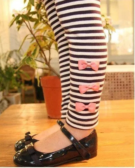Pink cotton jersey knit clothing set for a girl, showing short-sleeved top and elasticated waist trousers.
