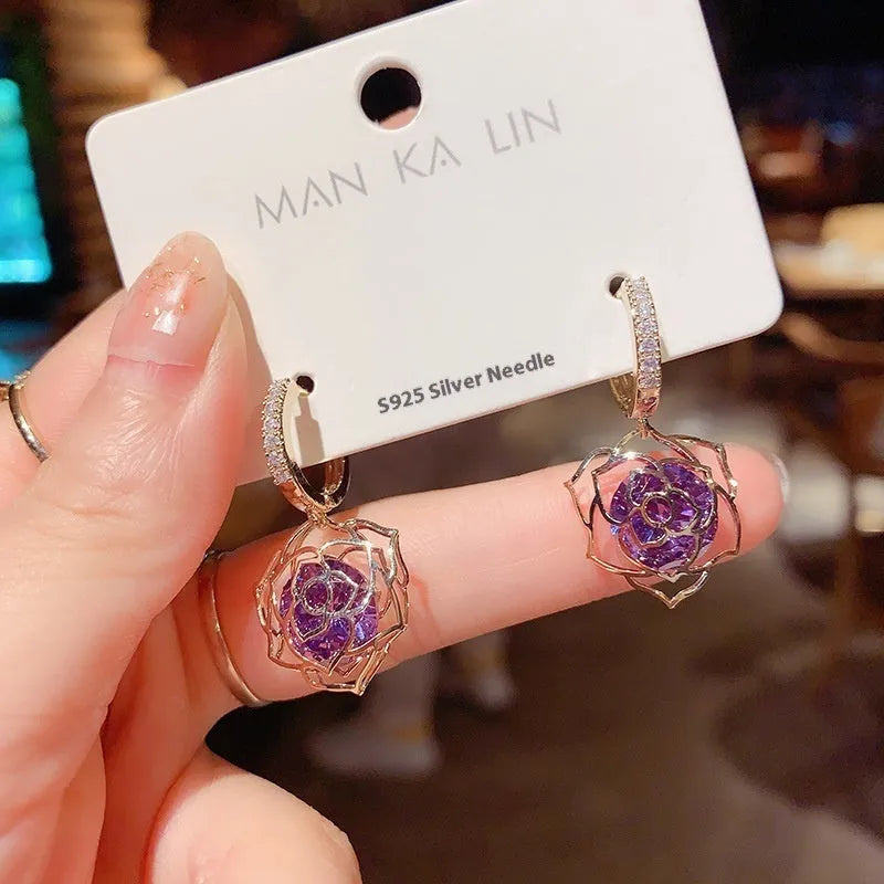 A pair of simple geometric rose-inspired earrings for women, made from electroplated copper, shown in one of the available colour types.