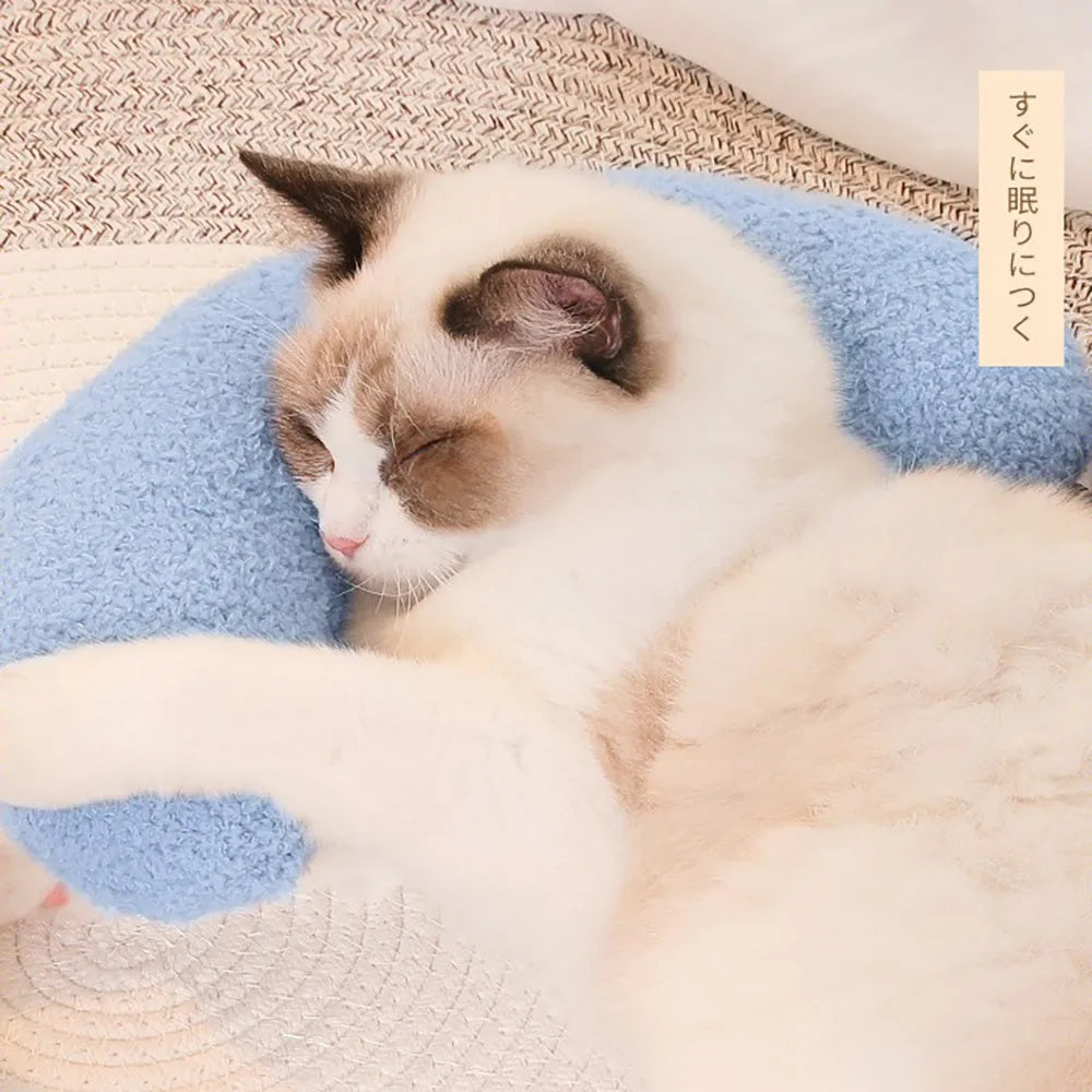 Blue U-shaped cat pillow with an integrated adjustable fabric collar on a grey blanket
