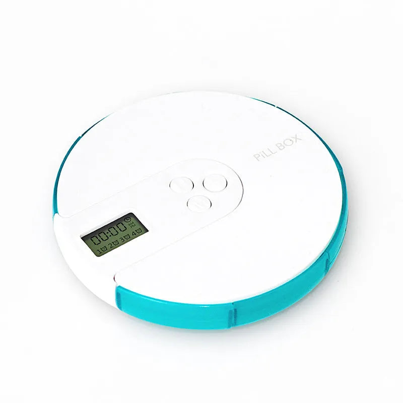 Blue seven-compartment alarm clock pill dispenser with digital display, shown next to pills.