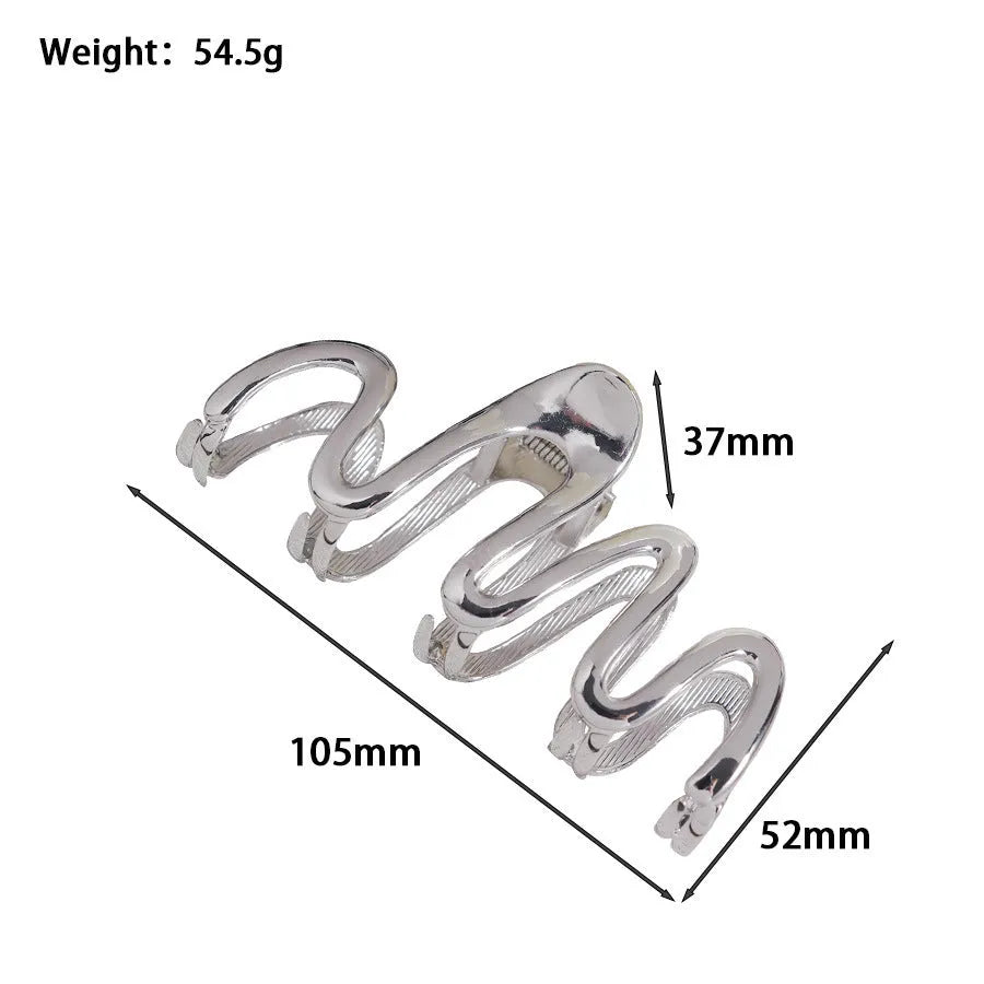 Assorted silver metal hair claws and barrettes including wave, knot, bow, and pearl designs on a white background.