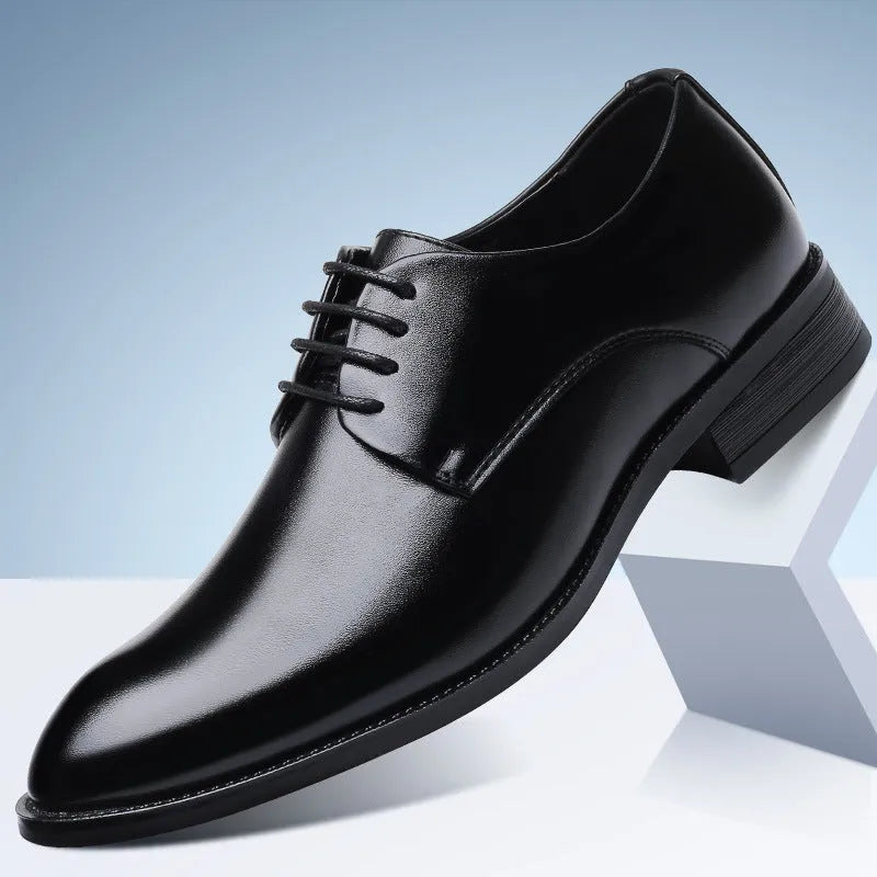Men's black leather dress shoes with low heel and front strap on white background