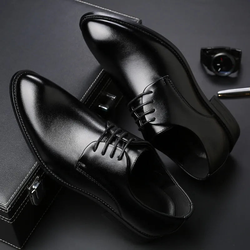 Men's black leather dress shoes with low heel and front strap on white background