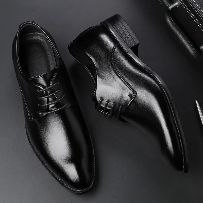 Men's black leather dress shoes with low heel and front strap on white background