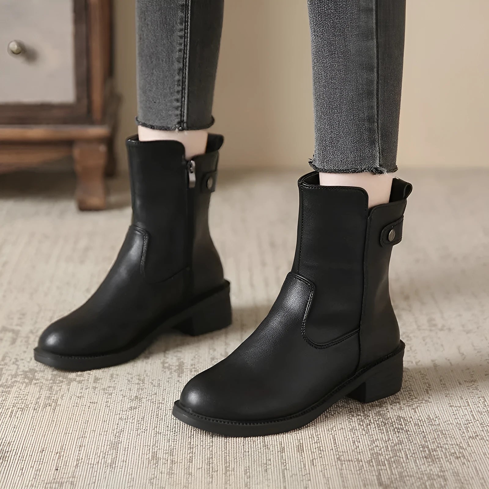 Black women's ankle boots with side zip, round toe, and a low block heel.