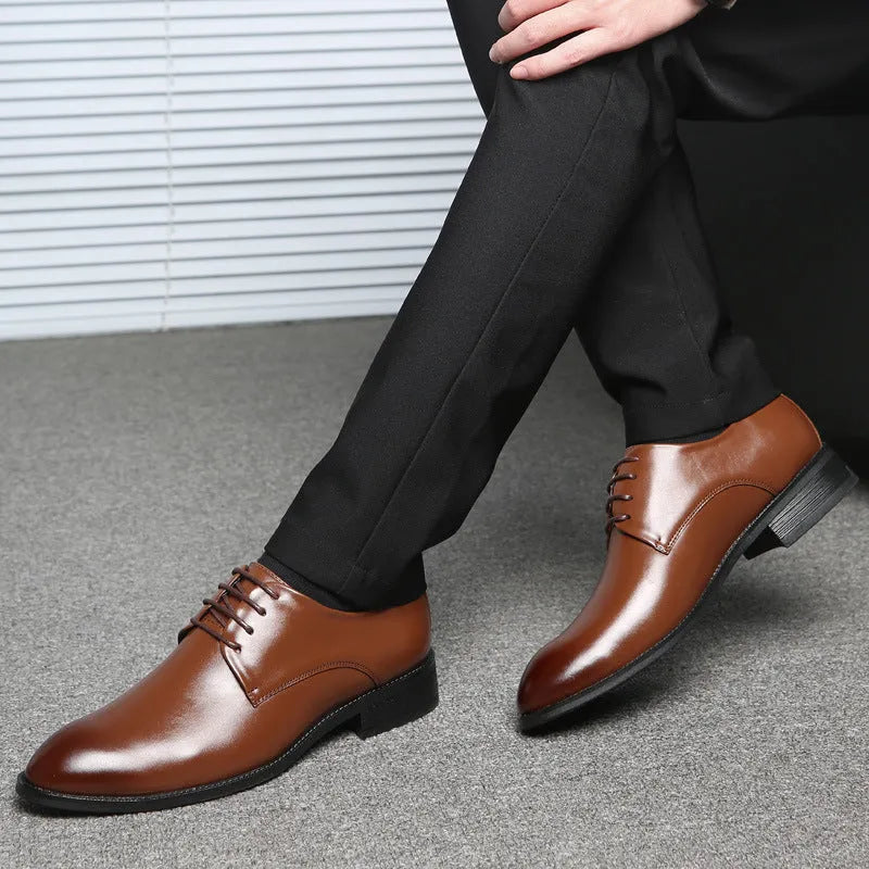 Men's black leather dress shoes with low heel and front strap on white background