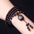 Zambian rosewood Buddha beads bracelet with flat lotus pendant showing 108 wooden beads