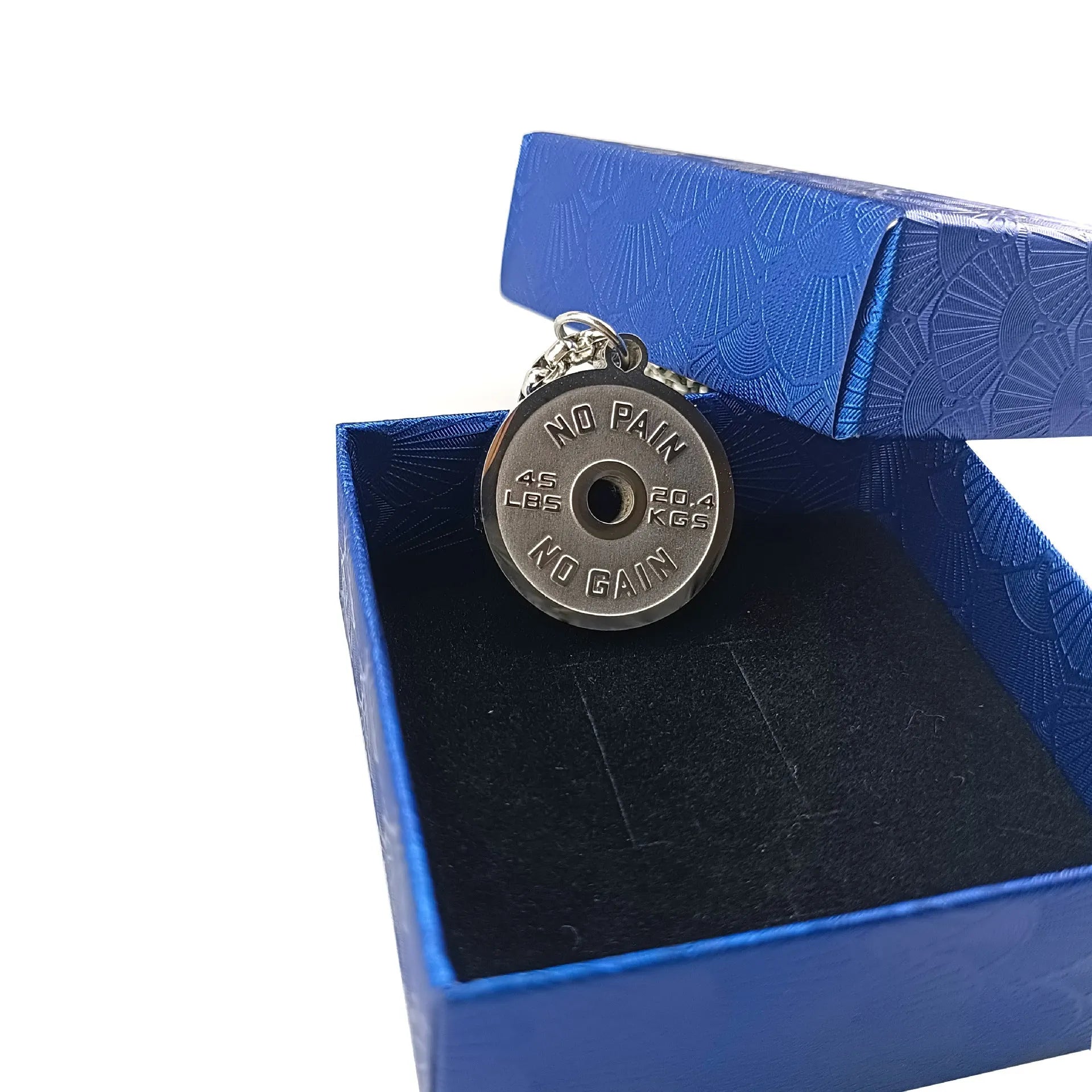 Polished stainless steel geometric barbell disk pendant on a choice of 60cm chains: black, gold, or pearl.