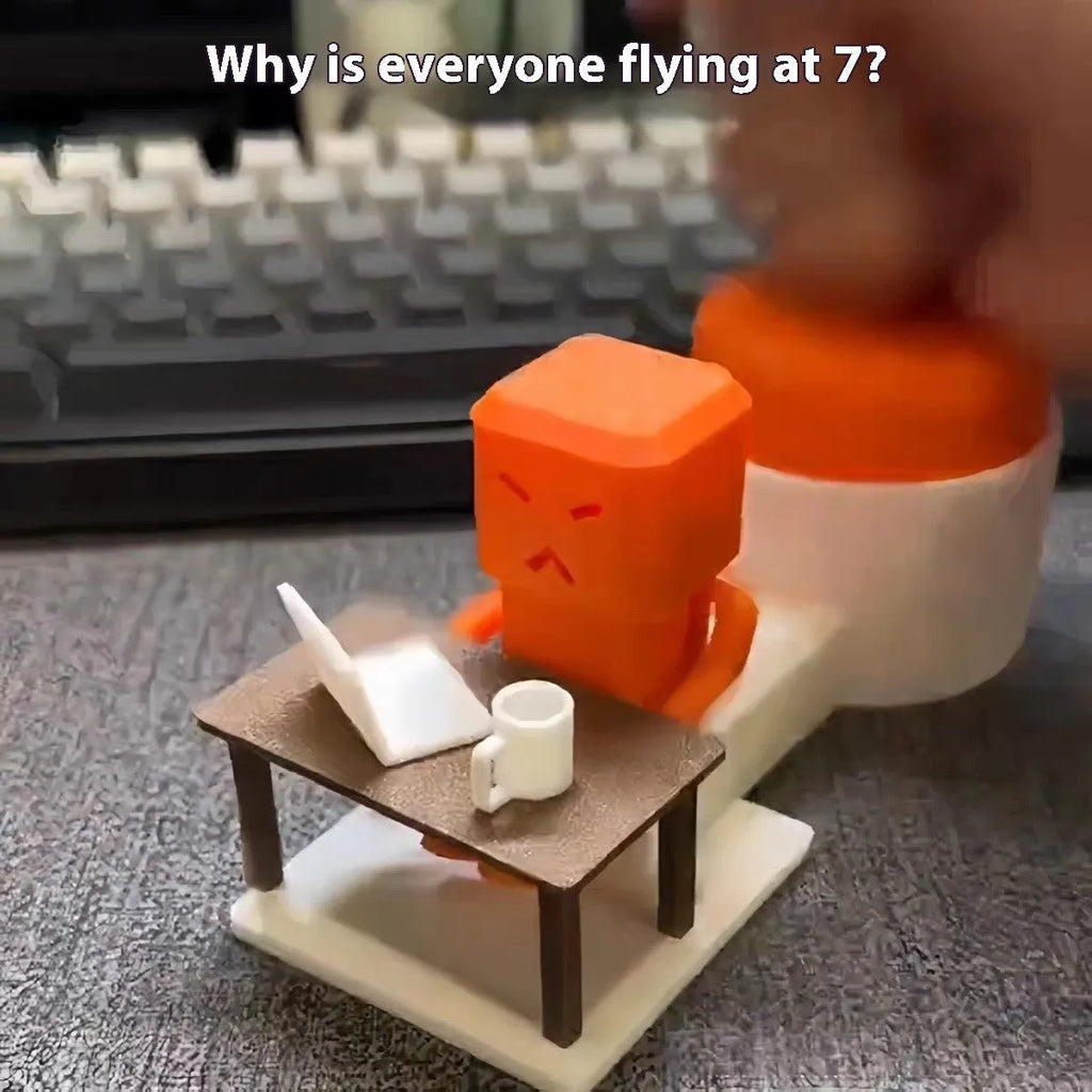 Orange plastic vent-themed table spinning decompression fidget toy on a desk.