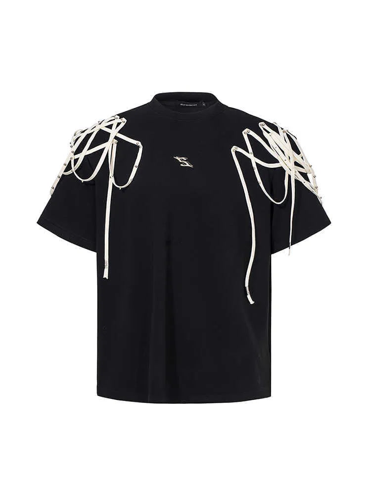 Black loose-fit short-sleeve t-shirt with padded shoulders featuring a decorative rivet and ribbon detail.