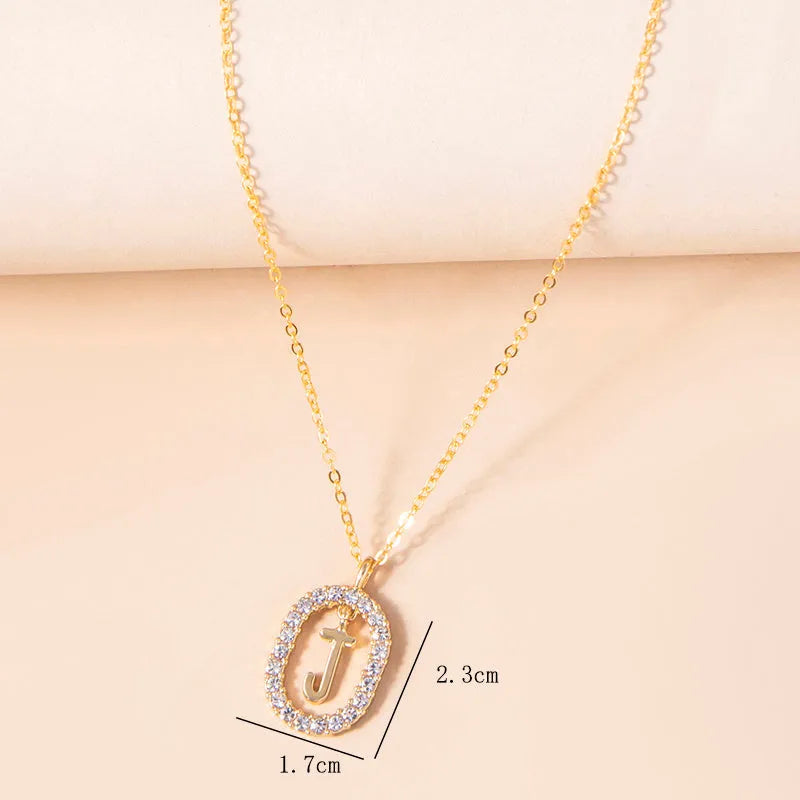Gold crystal letter initial oval pendant necklace on woman, rhinestone letter in zinc alloy frame with adjustable chain