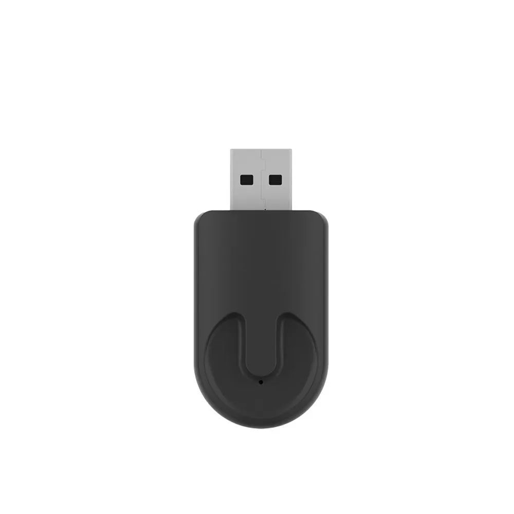 Small black Carplay USB wireless data adapter dongle on a car dashboard