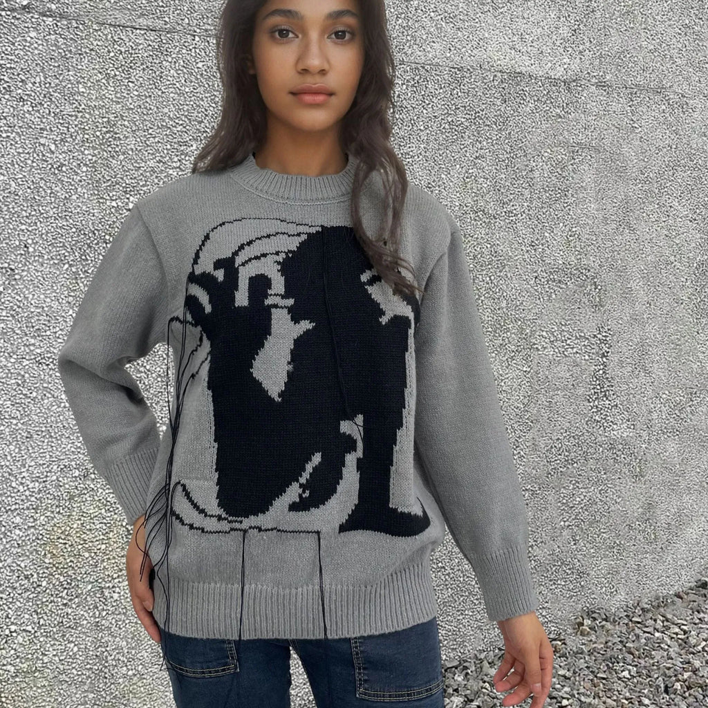 Women's grey alpaca wool sweater with tassel detailing and round neck.
