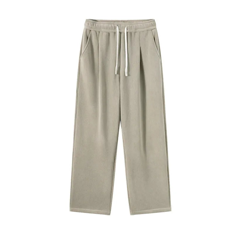 Men's double-sided polar fleece sports trousers in apricot, showing loose fit and drawstring waist.
