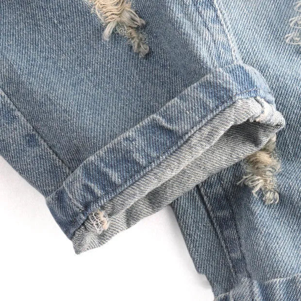 Light blue children's cotton skinny slim jeans laid flat showing slim leg and regular waist