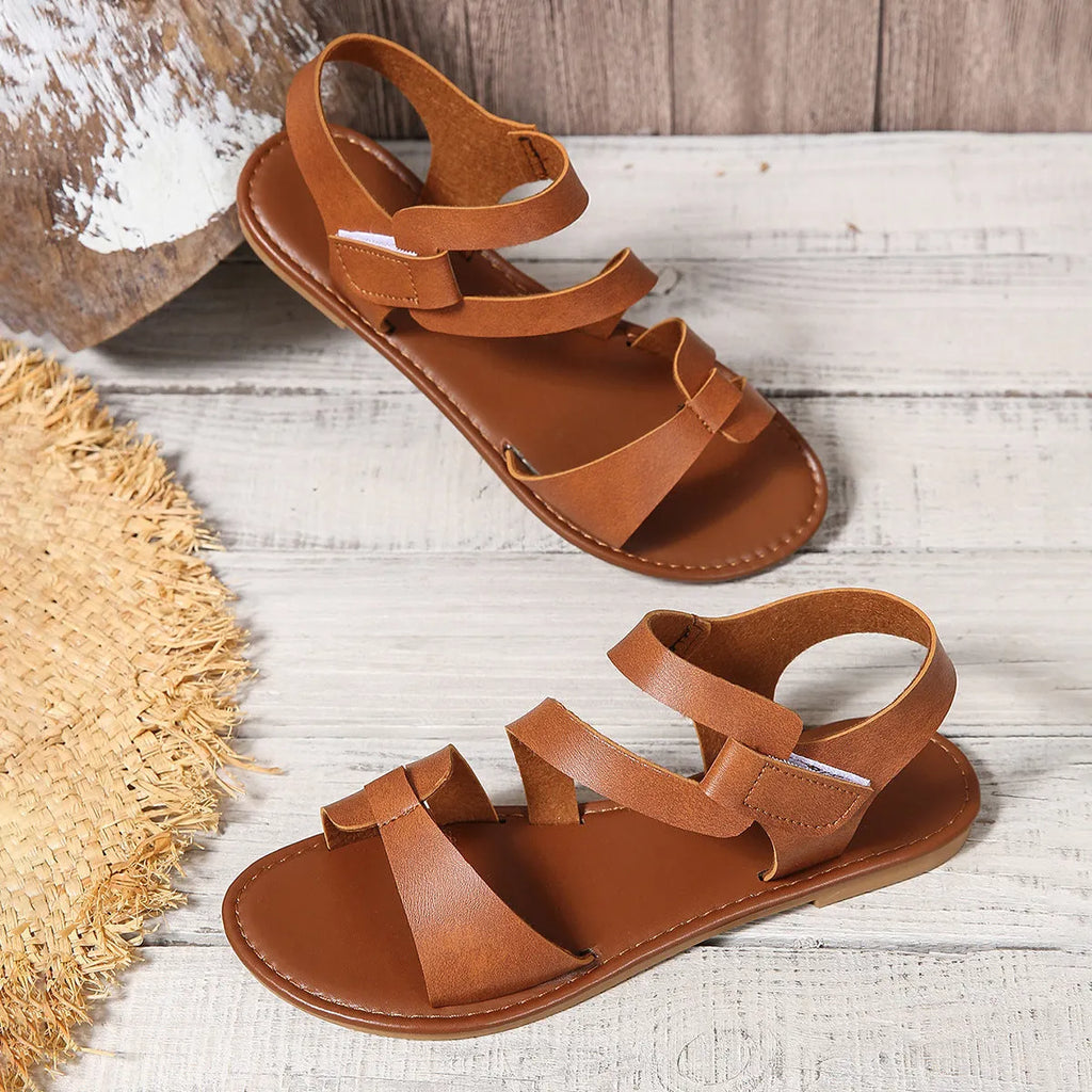 Women's flat sandals with Velcro strap in black, brown, and multicolour on a rubber sole.