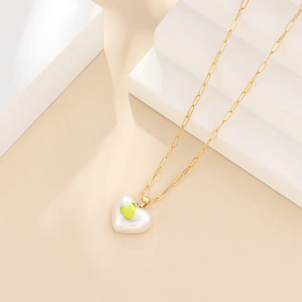 Geometric fruit pendant necklace with adjustable chain showing apple, pineapple, strawberry, cherry and pear designs