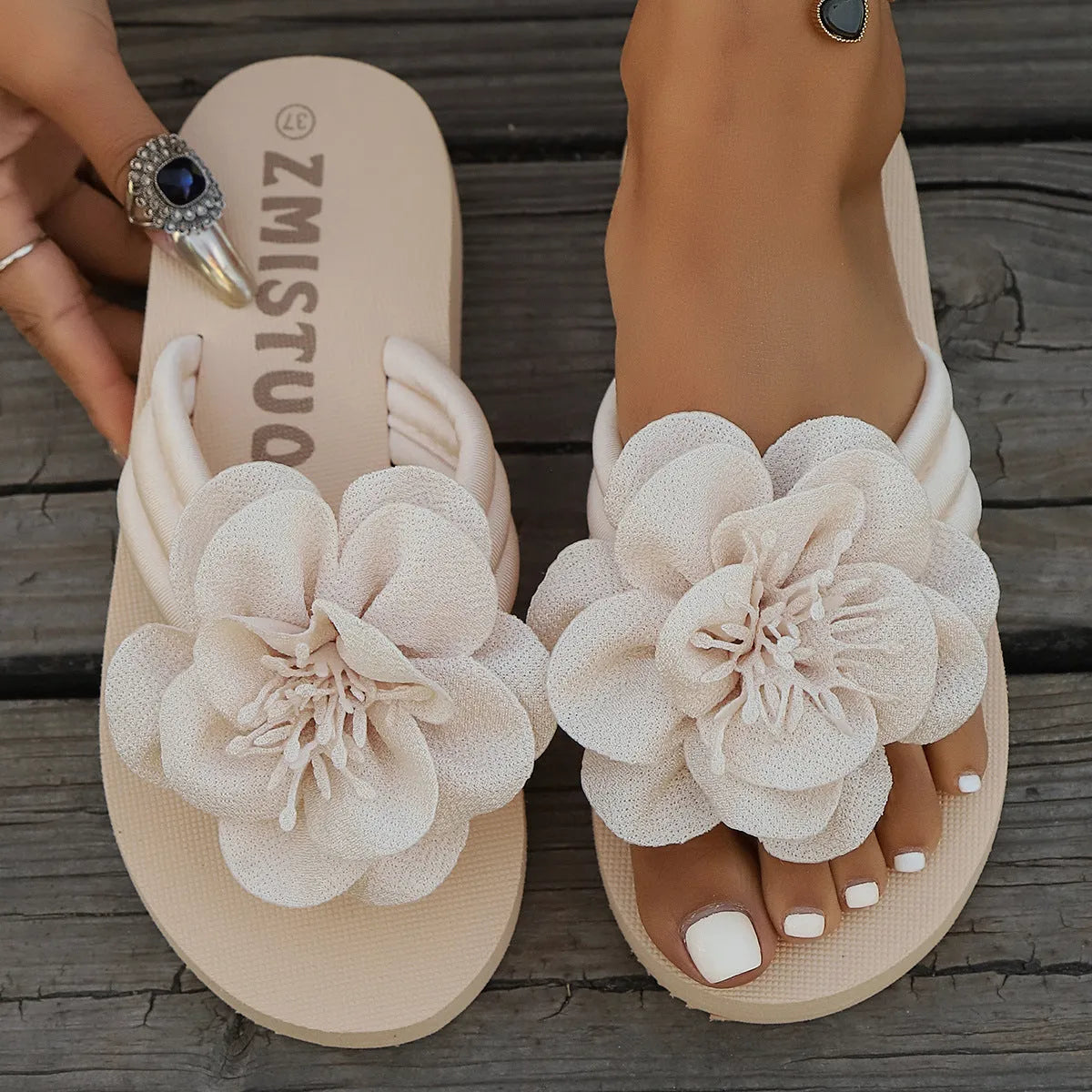 Women's solid colour PU upper flower flat toe flip-flop sandal in beige white, side view