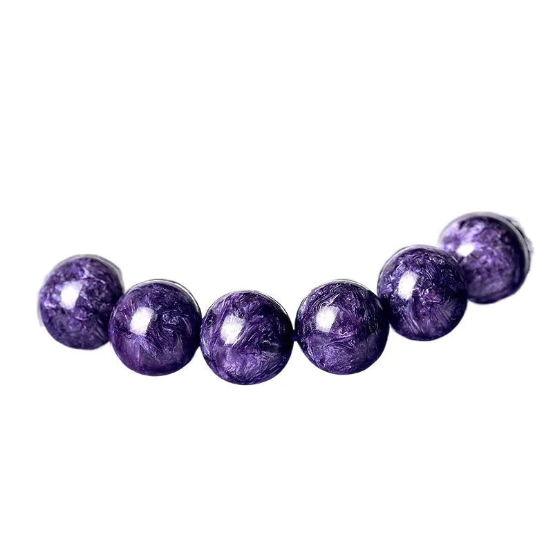 Natural transparent charoite crystal bracelet with platinum clasp, showing different bead size options.