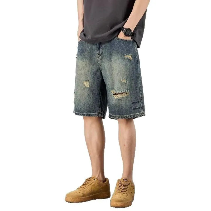 Blue retro loose hole men's denim shorts on a neutral background