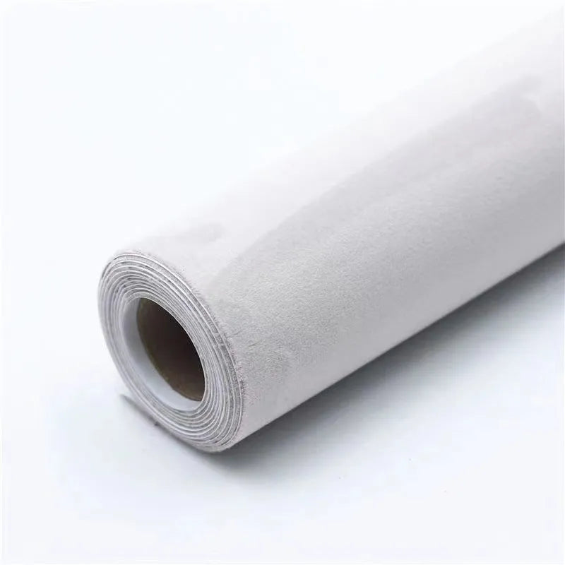 Rolls and sheets of coloured self-adhesive suede leather material for DIY projects.