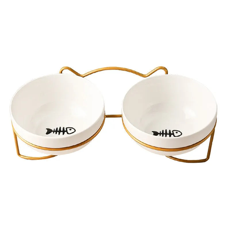 White ceramic cat bowl with cat paw print design on a black iron frame stand