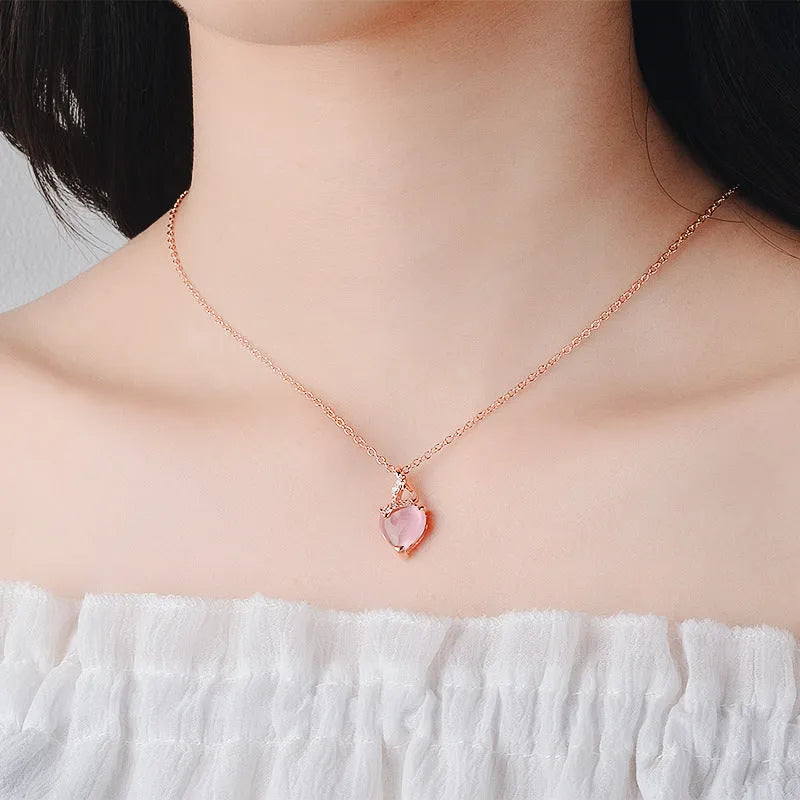 Women's heart-shaped pink crystal pendant with rose gold electroplated finish and matching cross chain