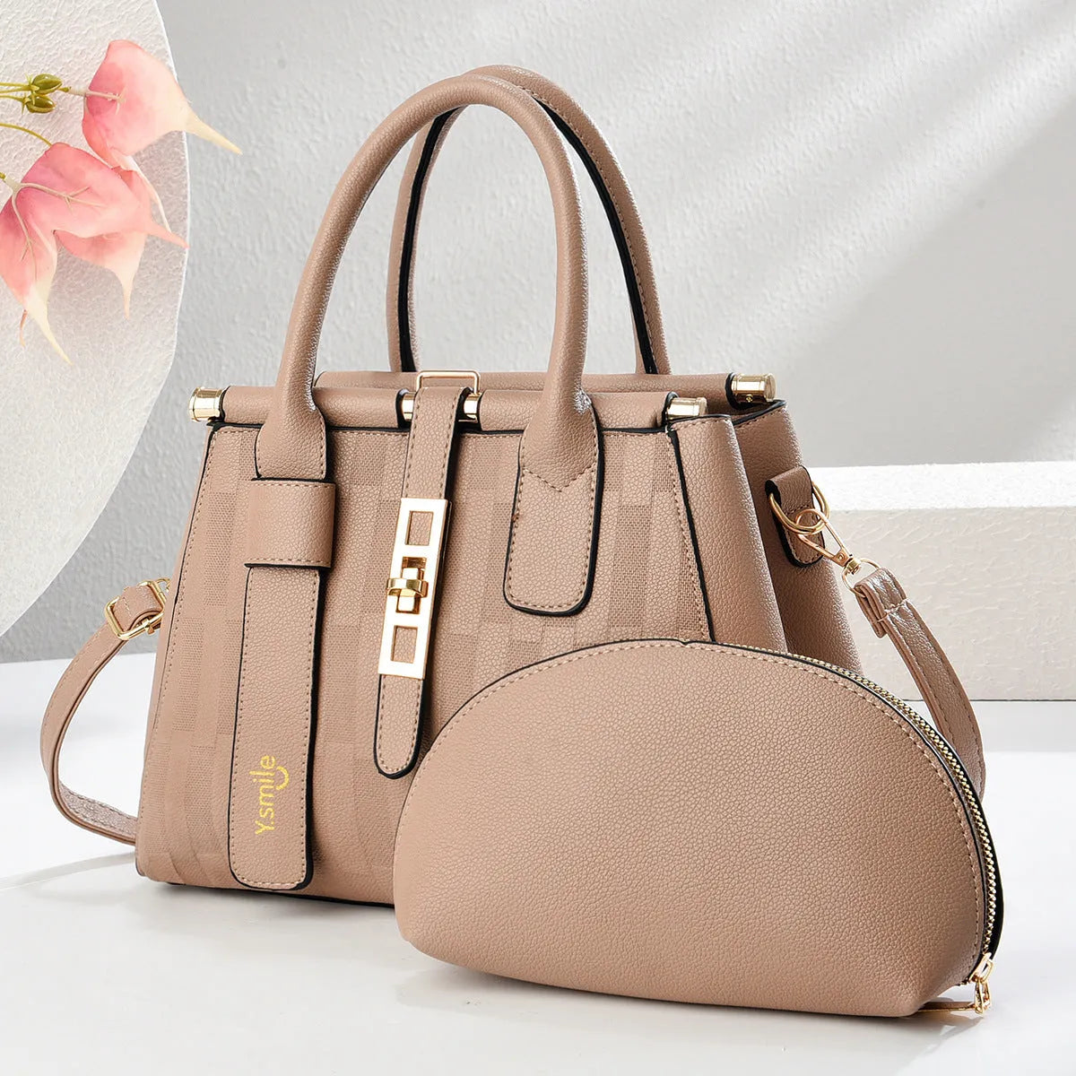 Round black PU handbag with crossbody strap shown alongside light khaki and purplish red colour options