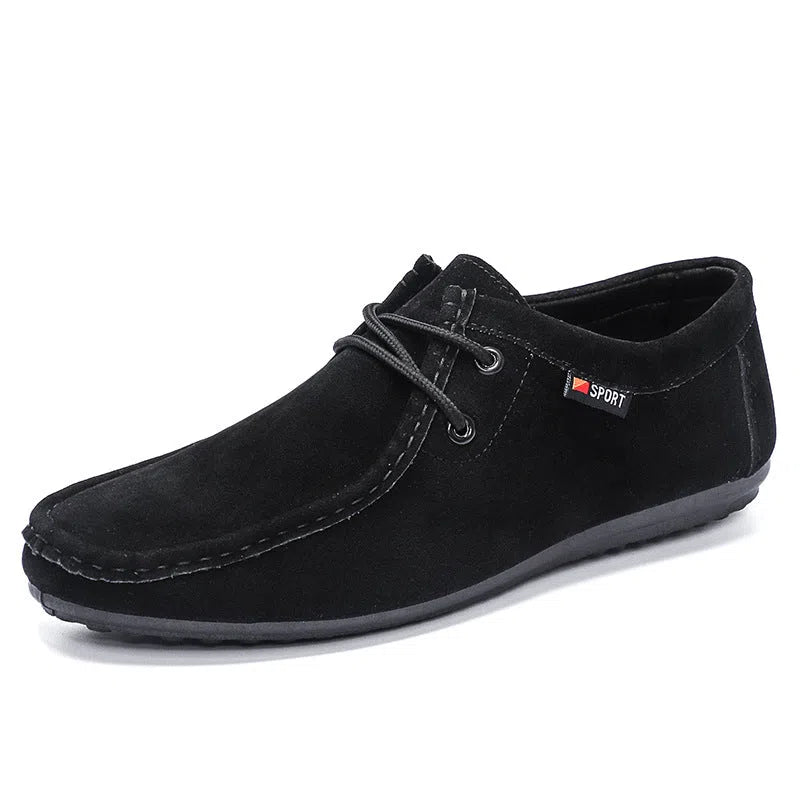 Men's black slip-on loafers with synthetic PU upper, stitched detailing, and non-slip plastic sole