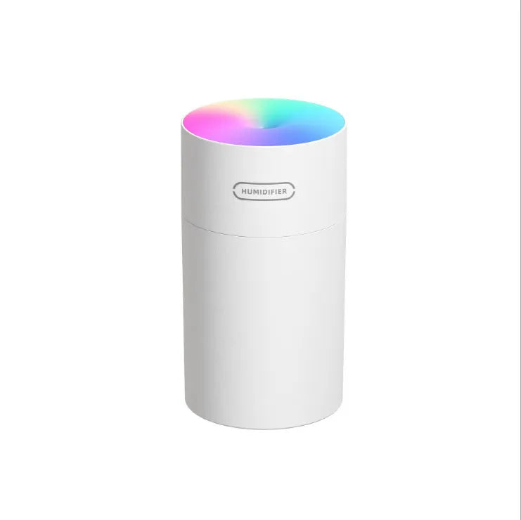 Pink USB desktop humidifier with colourful LED lights and 300ml water tank on wooden desk