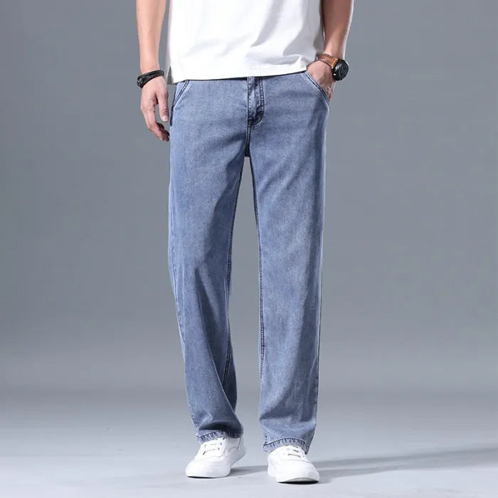 Men's light blue loose straight-leg lyocell jeans laid flat showing zip fly and relaxed fit