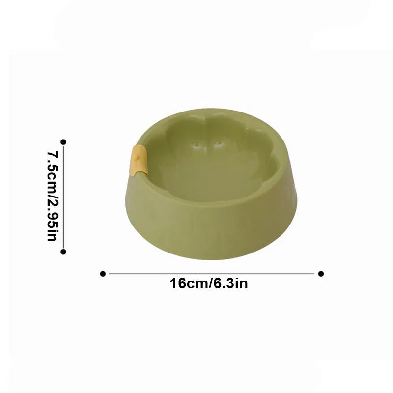 Green plastic double pet bowl feeder for dogs and cats on a white background