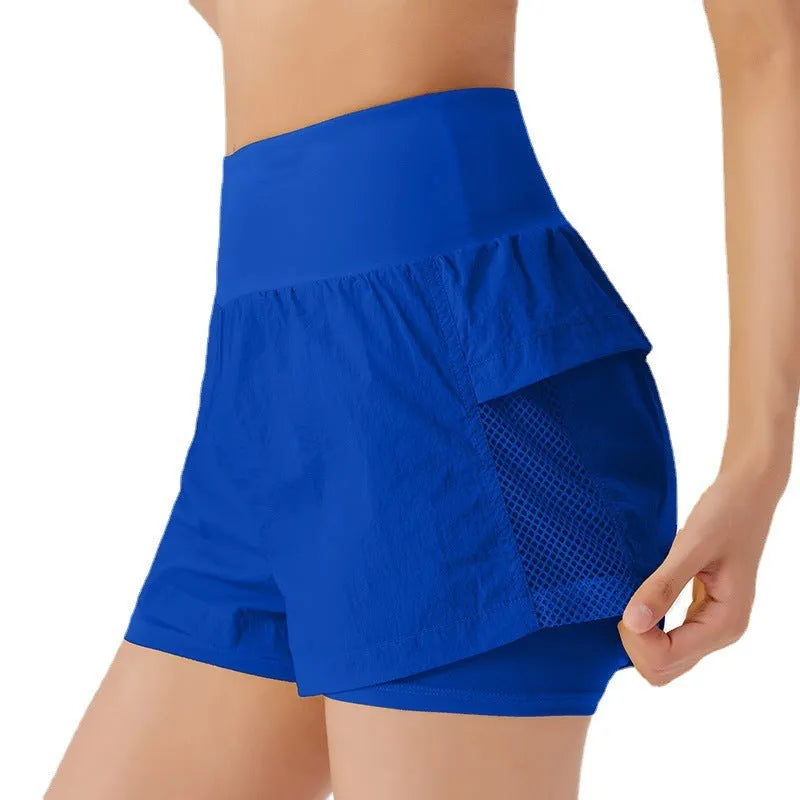 Women's loose fit cotton blend fitness shorts in lemon yellow colour on a hanger