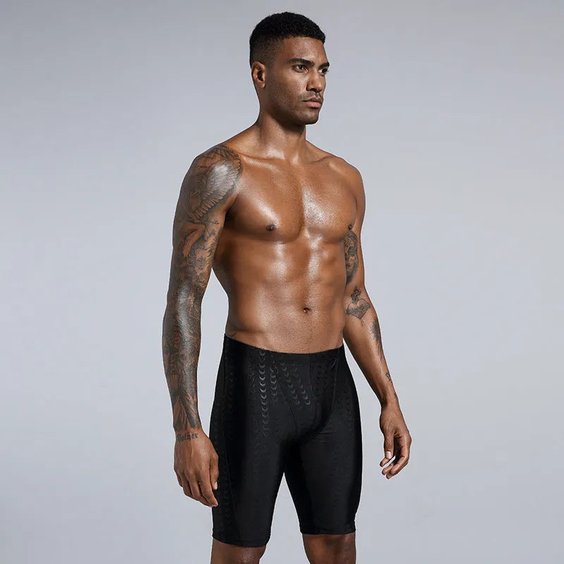 Men's solid colour waterproof shark skin fabric swimming trunks in pool setting