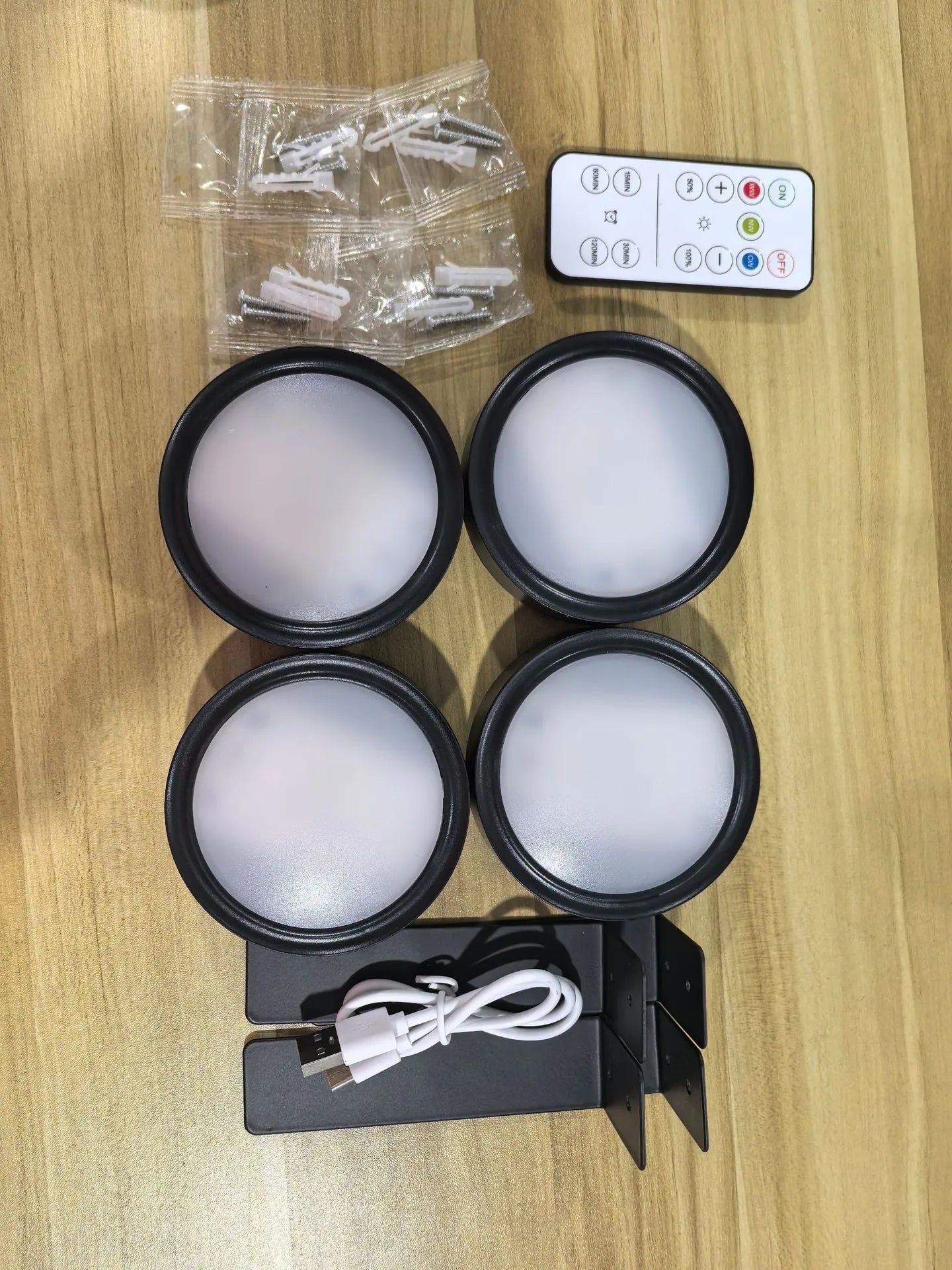 Wireless LED painting lamp with a magnetic mounting belt and remote control in black finish.