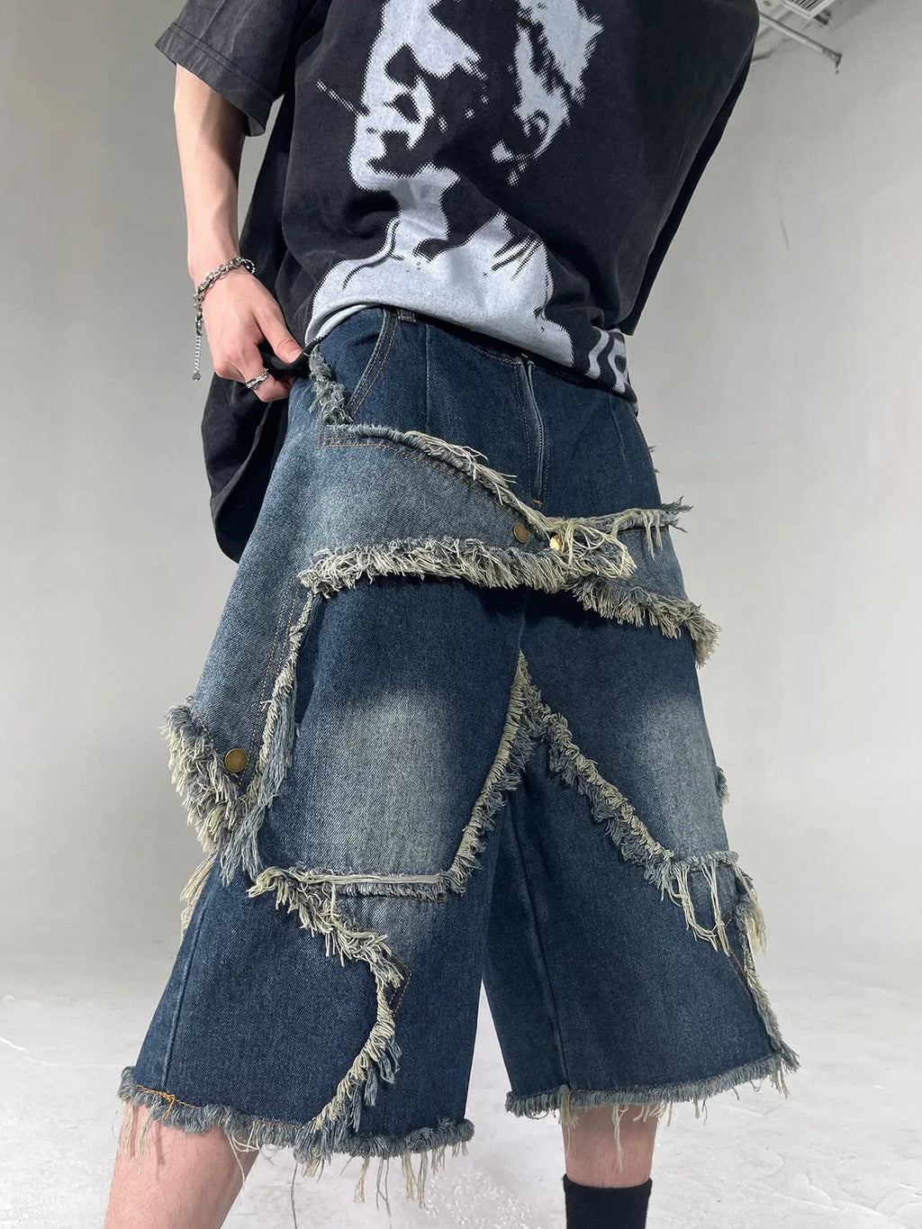 Blue denim shorts with frayed five-pointed star decoration in loose retro style