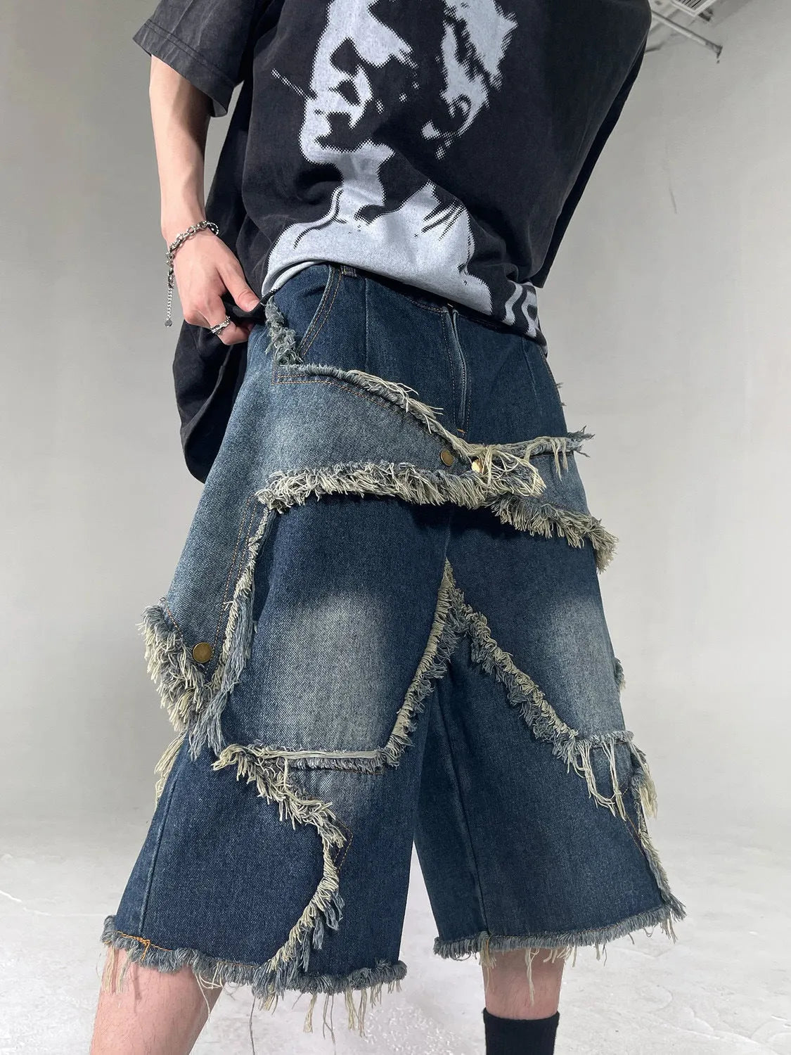 Blue denim shorts with frayed five-pointed star decoration in loose retro style