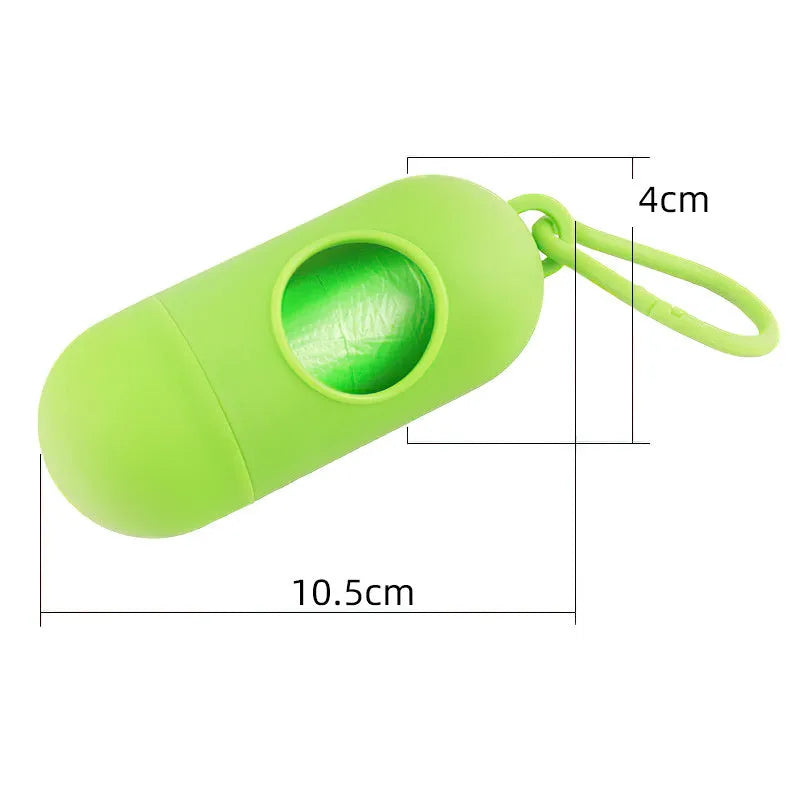 Black plastic dog poop bag holder with a metal side hook and Velcro strap, showing compact size.