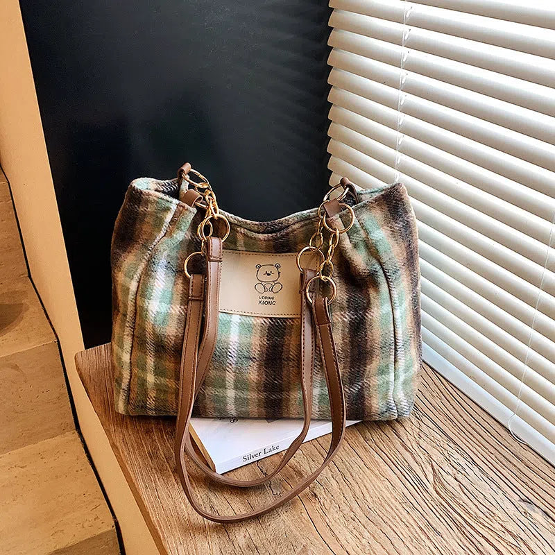 Wool plaid women's single-shoulder commuter bag in brown with stitched seam detailing and double straps