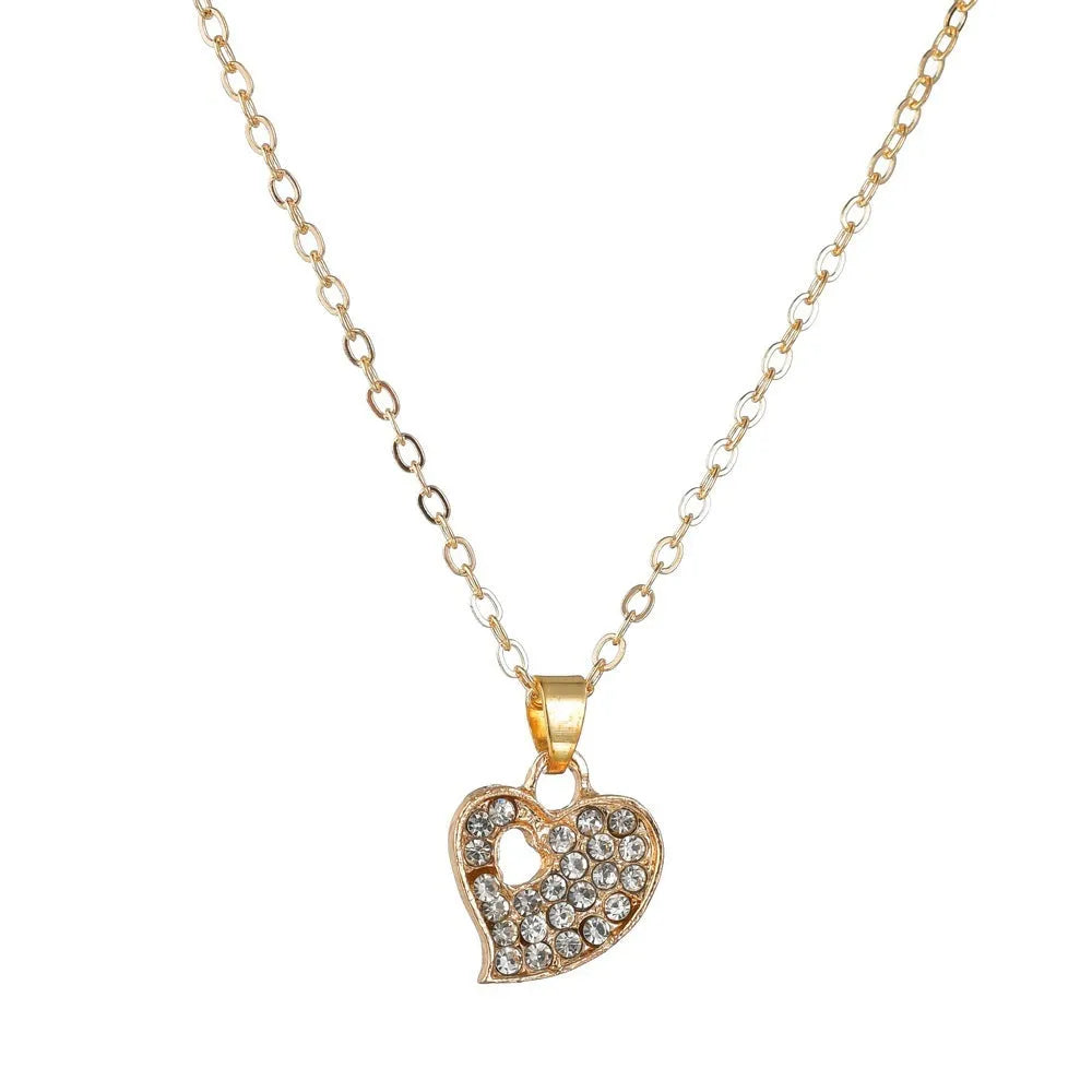 Gold electroplated women's jewellery set with love pendant necklace, earrings, and bracelet on a white background.