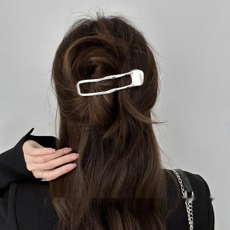 Gold and silver zinc alloy hair clip barrettes in arc, square, and triangle shapes.