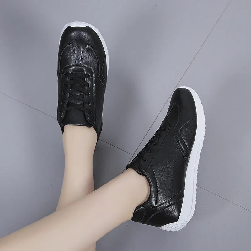 Women's white platform casual sneakers with thick sole, lace-up closure, and rubber outsole on a neutral background