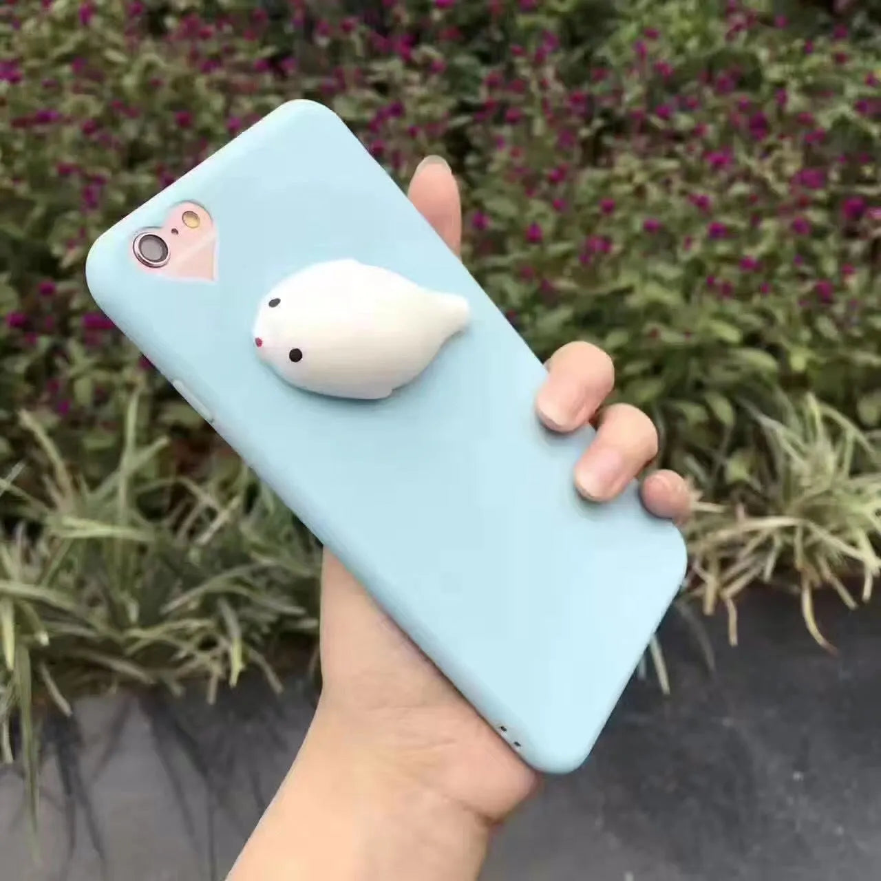 Soft silicone iPhone case with a raised 3D cartoon cat design in pink.