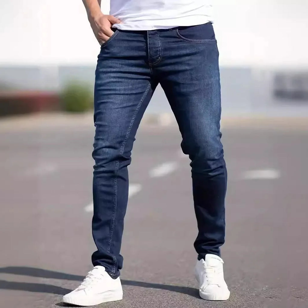 Men's dark blue slim casual jeans with street fashion styling and mid waist design